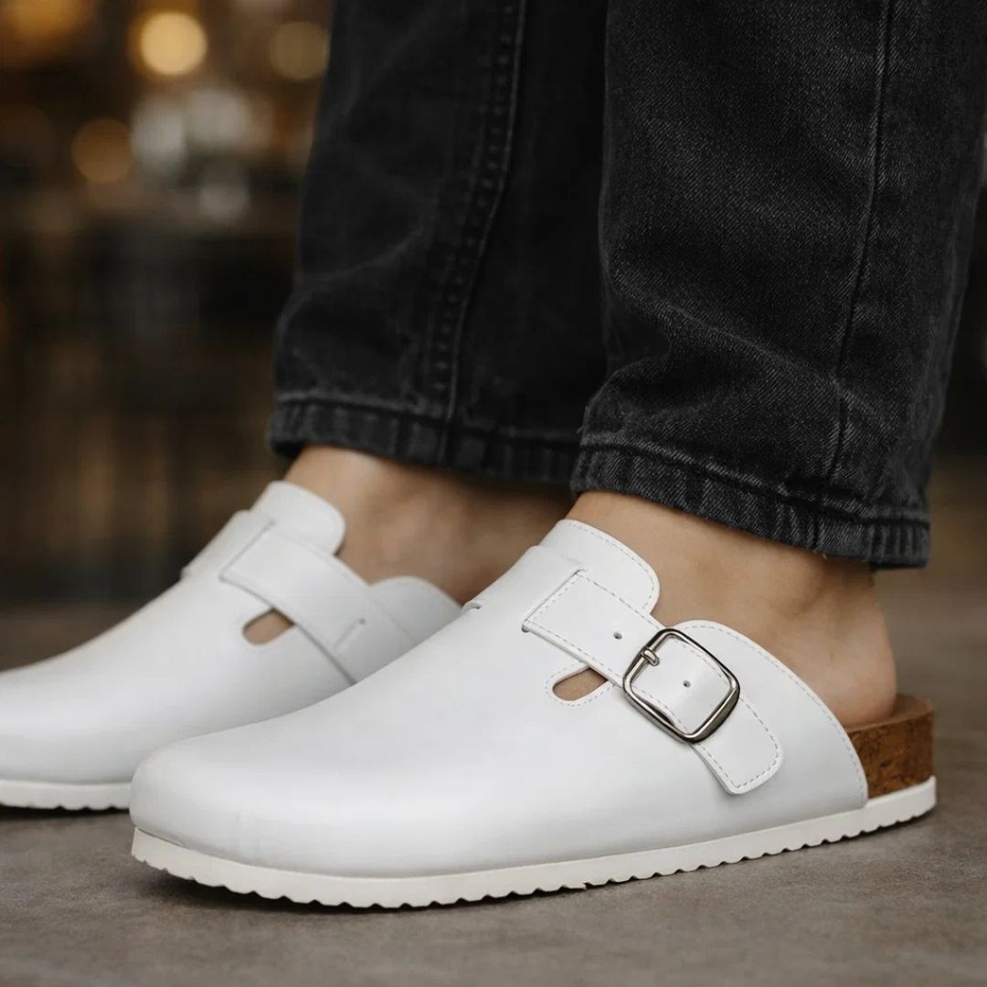 White clogs with a buckle on a blurred background