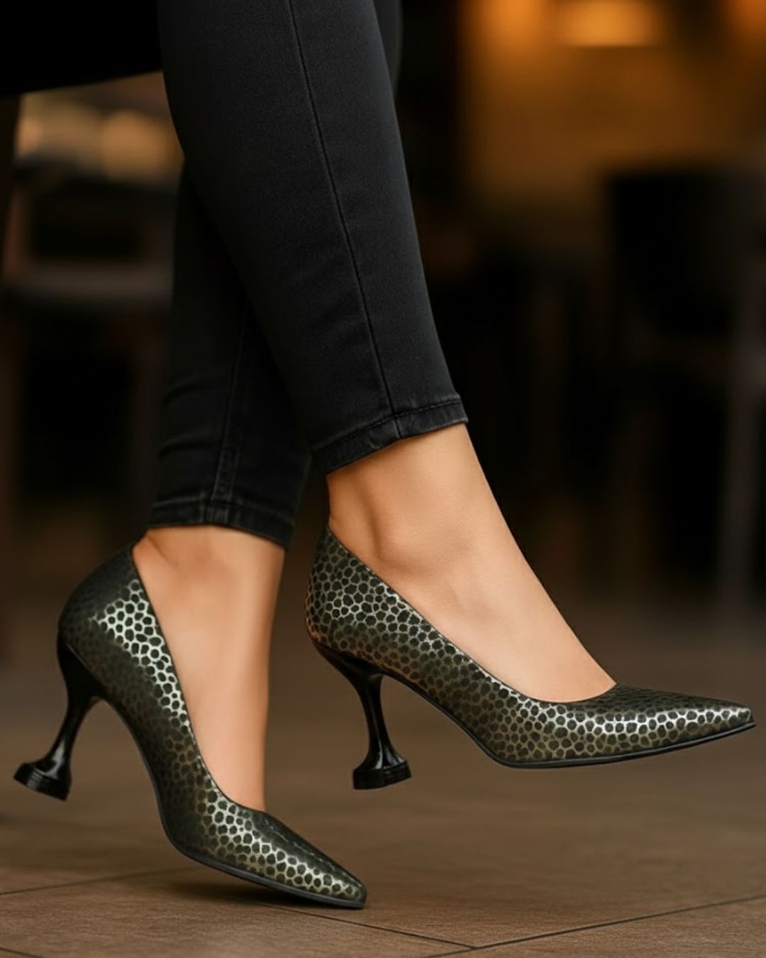 High-heeled shoes with a pattern worn by a person in a blurred indoor setting
