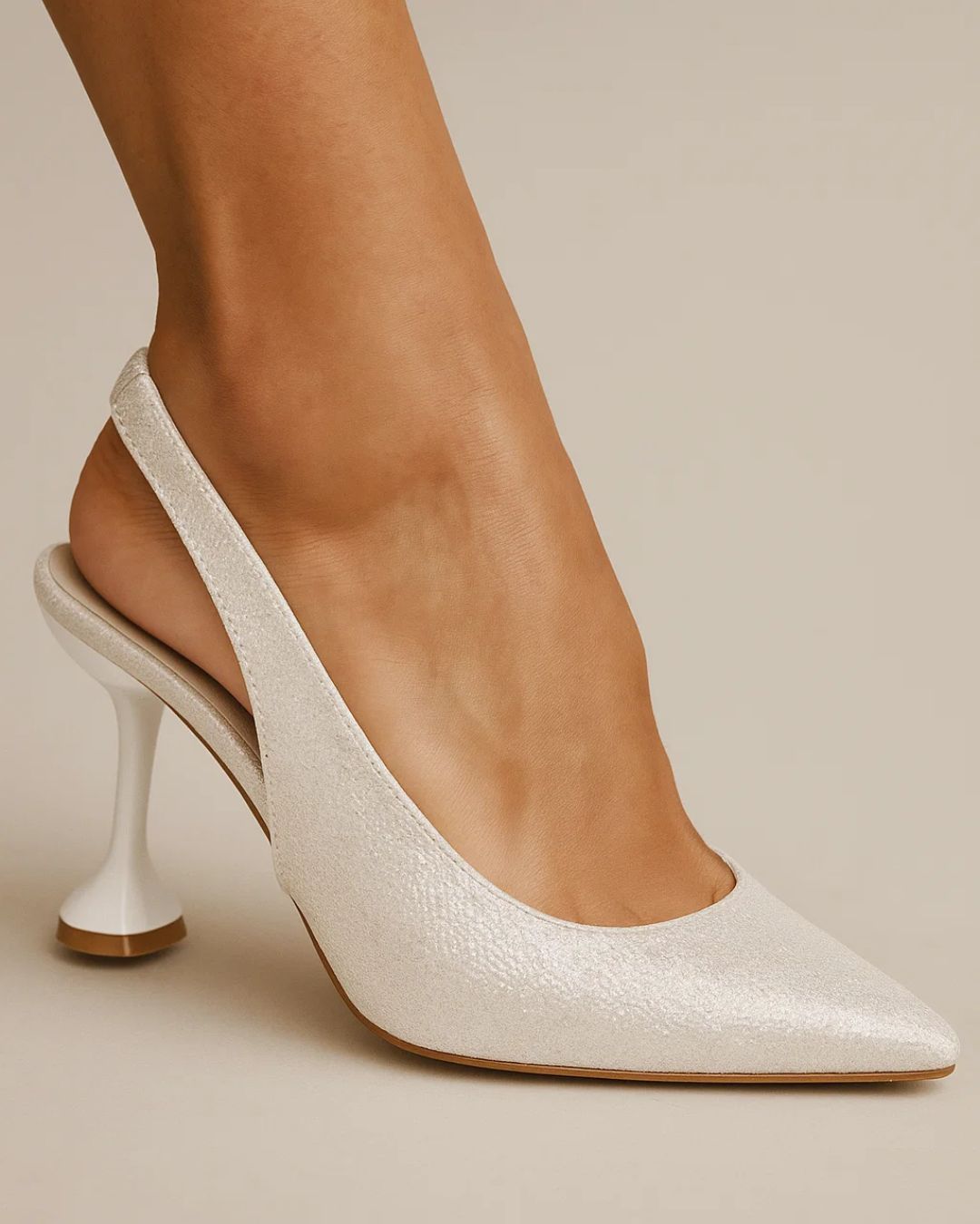 White high-heeled shoe on a neutral background