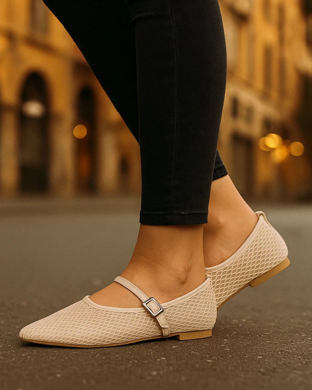 Beige woven shoes worn with black pants on a blurred street background