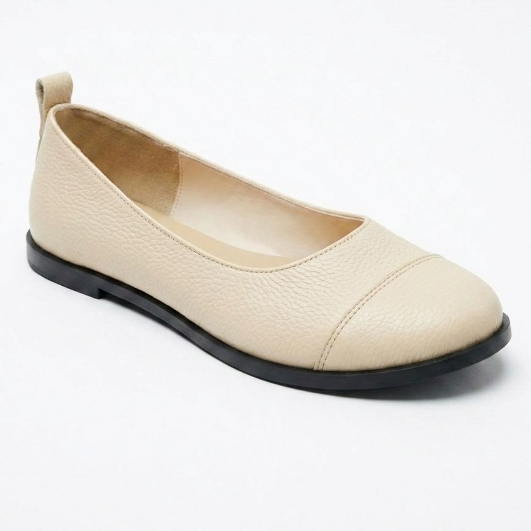 Beige flat shoe on a white background