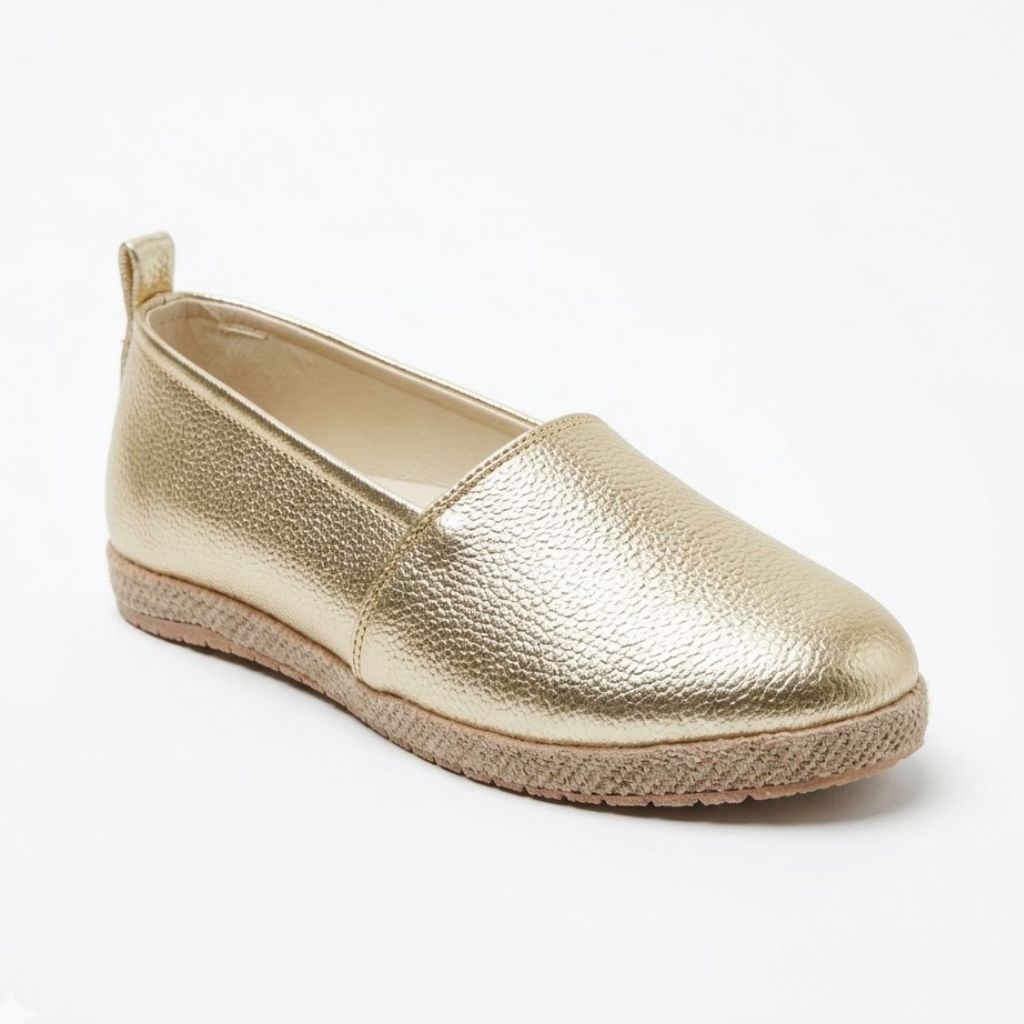 Gold espadrille shoe on a white background