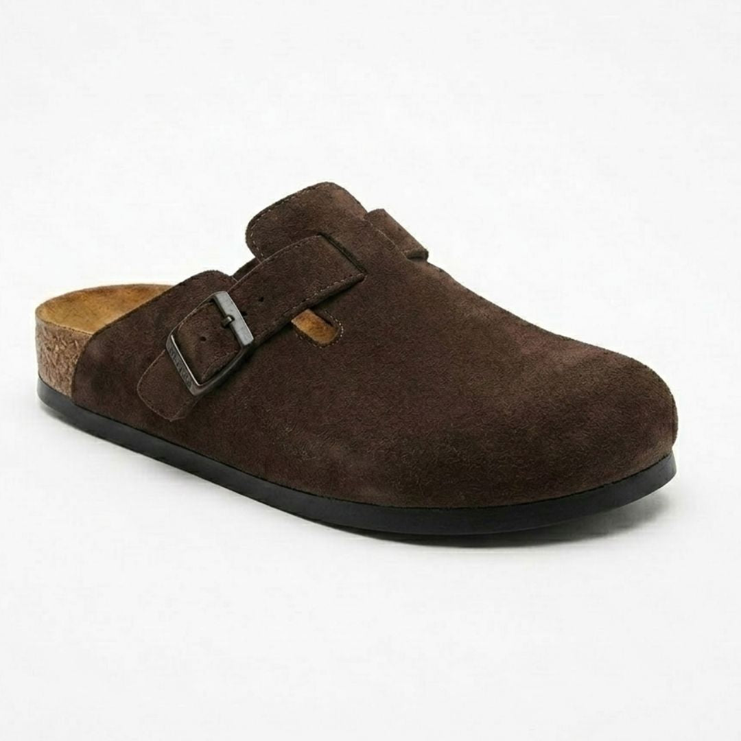 Brown suede clog shoe with a buckle on a white background