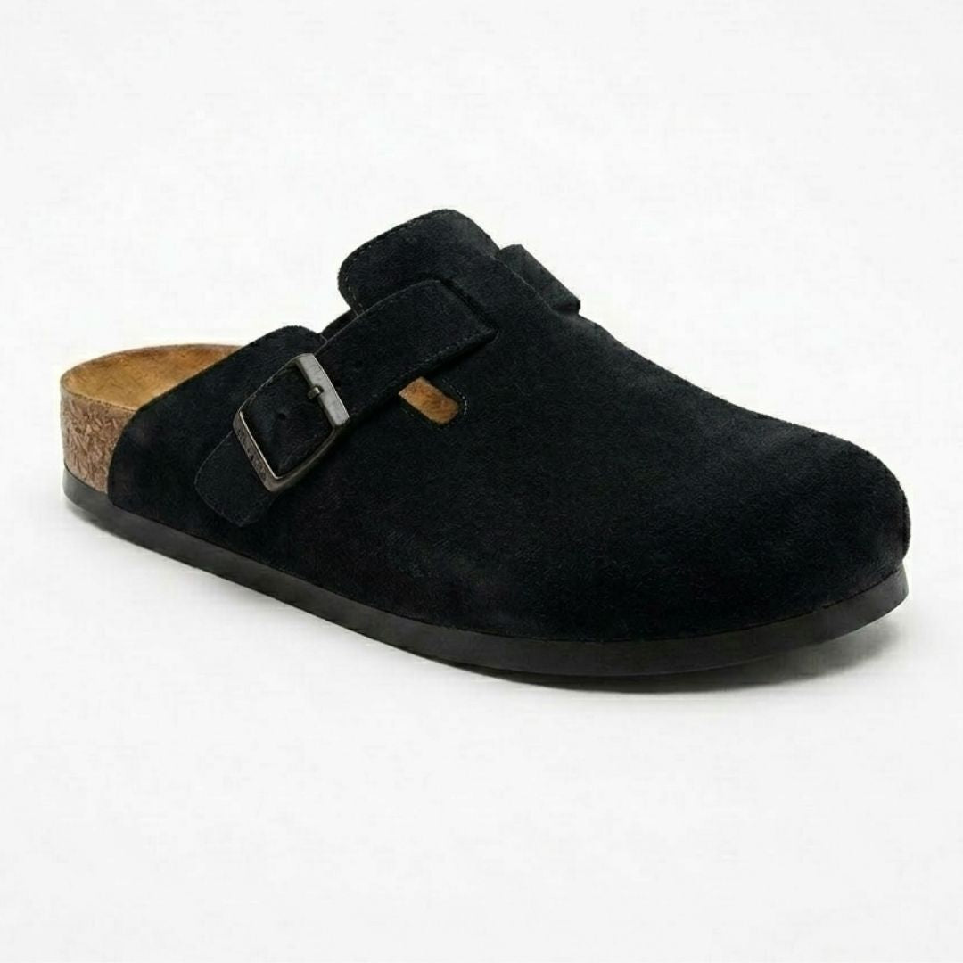 Black suede clog shoe with a buckle on a white background