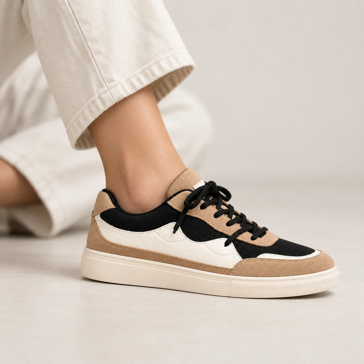 Model wearing the Shoppingooo tri-tone sneaker, profile view
