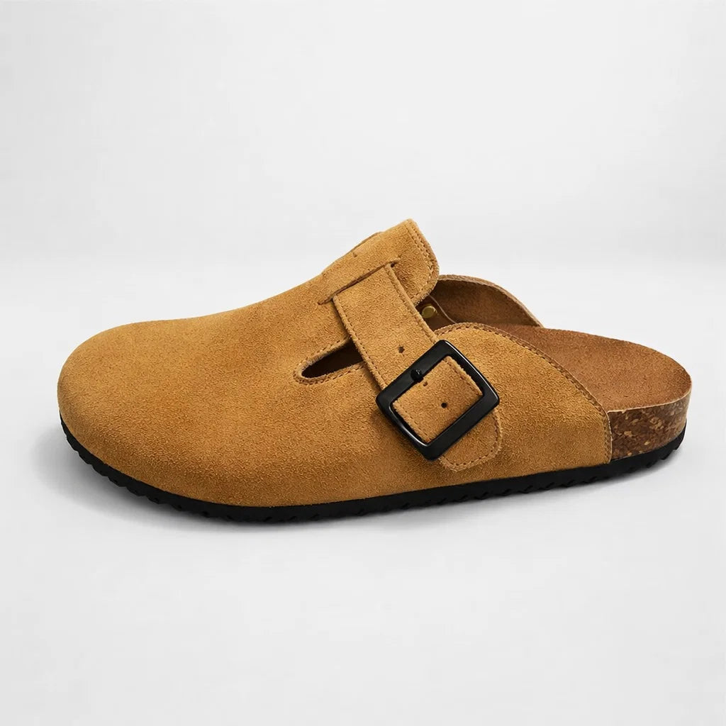 Brown suede clog shoe with a black buckle on a light gray background