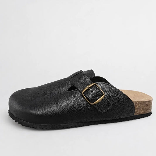 Black leather sandal with a buckle on a light gray background